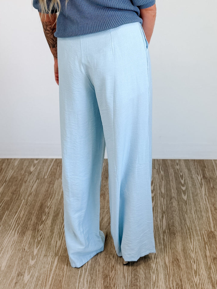 Elegant high-waisted, wide-flowing trousers in blue