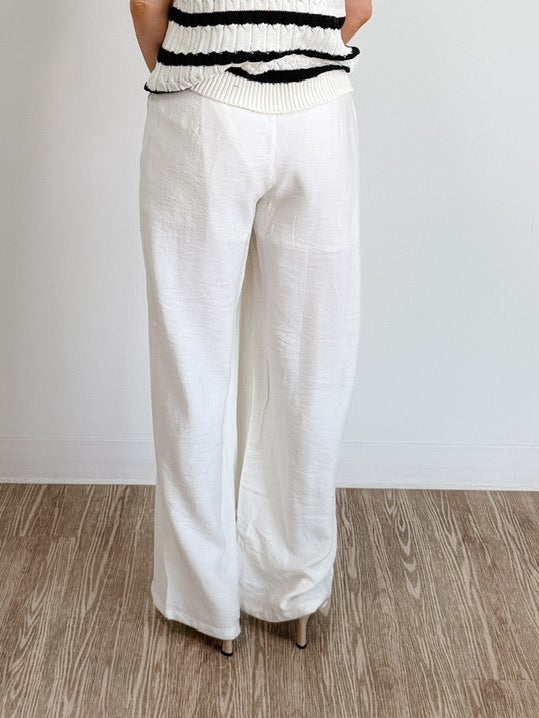 Elegant high-waisted, wide-flowing trousers in off-white